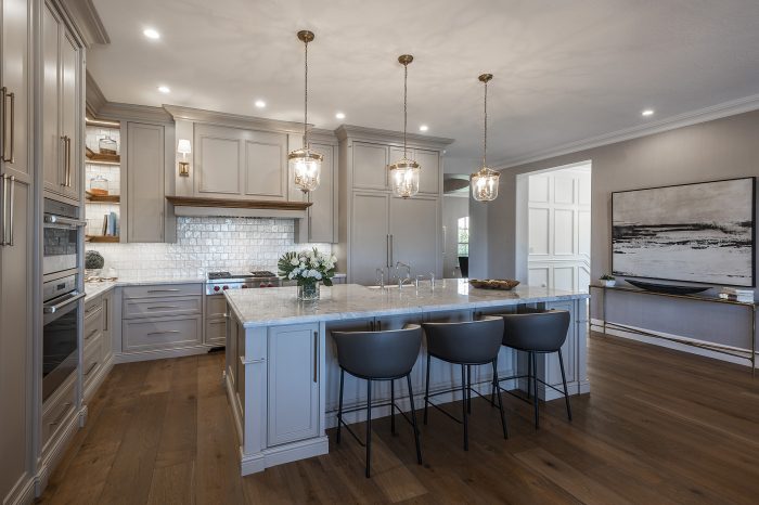 Contemporary kitchen featuring white cabinets and gray counter tops.